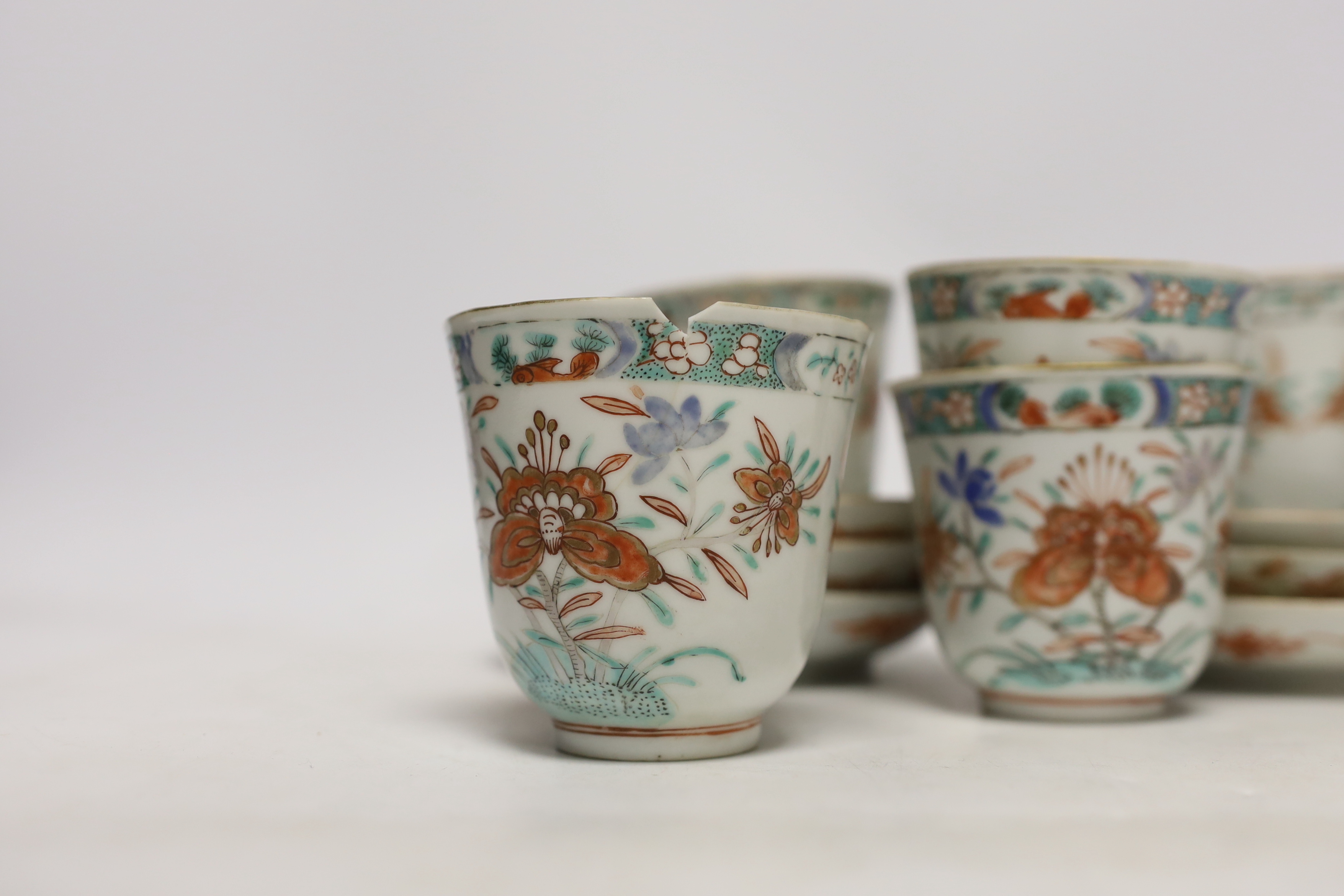 A set of six early 18th century Chinese cups and saucers with Dutch enamelled decoration, c.1710, 7.5cm high
